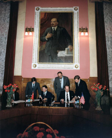 attorney general signing cooperative agreement with soviets on nazi-hunting under lenin portrait, 1989 